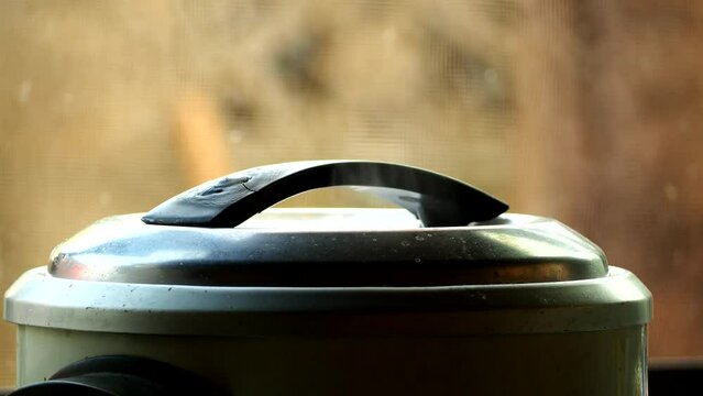 Electric rice cooker is steaming rice, in door  Chiangmai  Thailand.