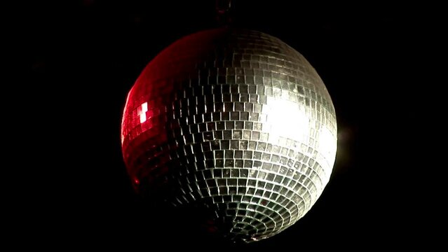 Disco party balls on ceiling in a nightclub room. Close up sparkly silver disco balls. Party concept. Mirror ball Illumination dark. Close up disco ball against a dark background.