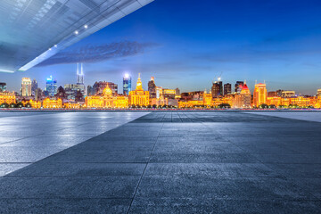 City Square floor and Shanghai skyline with modern buildings at night. Famous Bund architectural...