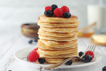 Pancakes with berries in rustic style	