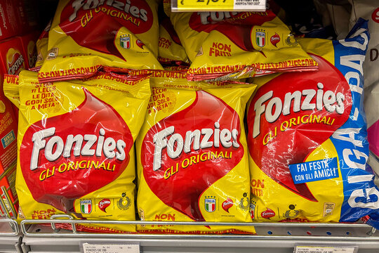Italy - December 24, 2023: FONZIES original crispy cheese corn snacks in pouches displayed for sale in Italian supermarket. Fonzies is a brand of Mondelez International