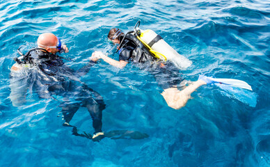 experienced diver instructor teaches a beginner diver to dive in Egypt