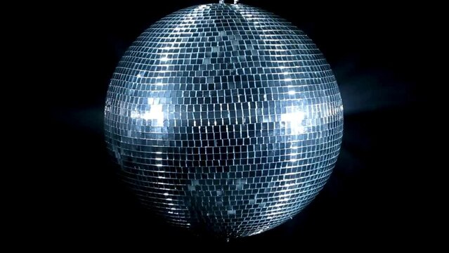 Close up disco ball against a dark background. Disco ball reflection light at night. Disco party balls on ceiling in a nightclub room. Close up of sparkly silver disco balls. Party concept.