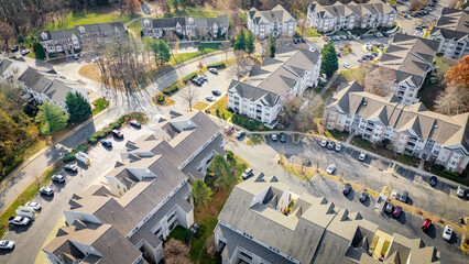 Drone Aerial Looking Down on Townhome Community Rooftops with Views of Street, Cars & Roofing