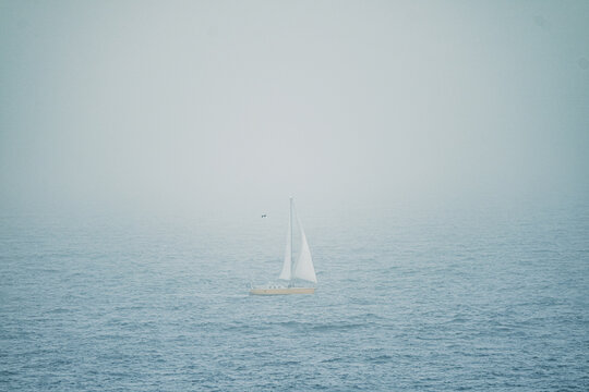 Sailboat in the ocean in the dust of calima on the Canary Islands, Spain.