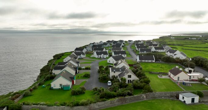 White houses against the ocean on a cloudy day in 4k