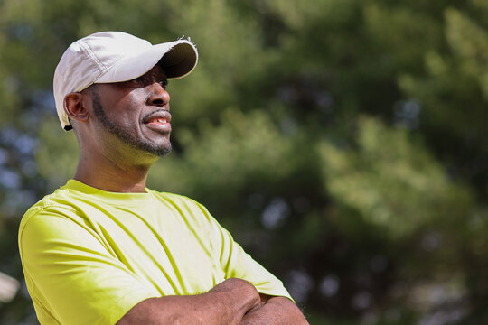 A Portrait Of A Black Man Smiling And Looking Away