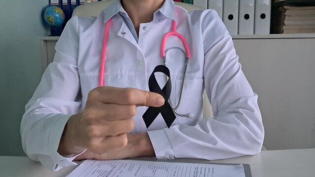 Awareness of black tape in doctor hand for melanoma and skin cancer and narcolepsy