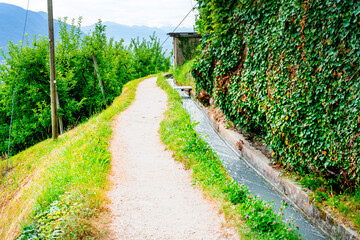 Hiking along the Marlinger Waalweg near Meran in South Tyrol Italy. With some Views over wineyards, the City of Meran, Marling and other Villages