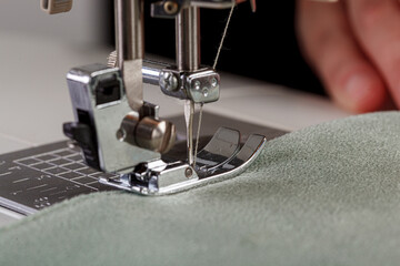 Sewing machine, stitching fabrics, needle in a round plan