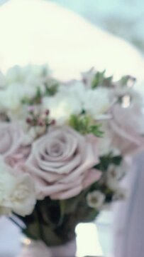 beautiful wedding bouquet of the bride of white roses and green eucalyptus close-up, romantic atmosphere before the outdoor ceremony, floristry and decoration