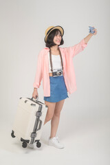 Young happy asian tourist woman over white background studio, travel and holidays concept.