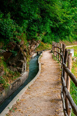 Obraz premium Hiking along the Marlinger Waalweg near Meran in South Tyrol Italy. With some Views over wineyards, the City of Meran, Marling and other Villages