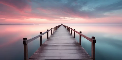 Foto op Canvas  a wooden pier over a calm lake during sunrise © grigoryepremyan