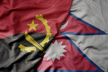 big waving national colorful flag of nepal and national flag of angola .