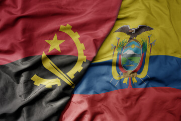 big waving national colorful flag of ecuador and national flag of angola .
