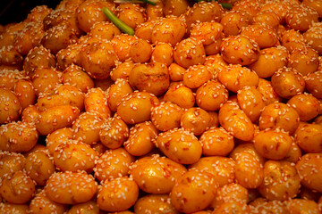Close-up of golden sesame potatoes, a popular street food in Wuchang , China. The image captures rich textures and colors.