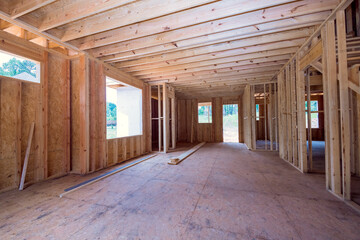 Under construction, framing of wood supports beam in new unfinished residential home