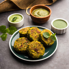hara bhara kabab or kebab is indian vegetarian snack recipe served with green mint chutney over moody background