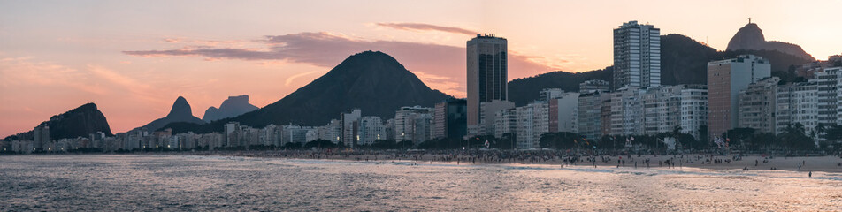 Golden Dusk Over Copacabana Beach with Rio Landmarks Silhouettes
