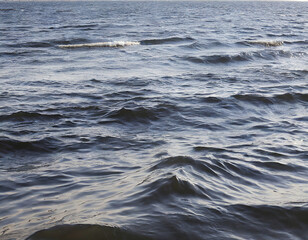 Fototapeta premium Water surface with waves and foam on the water surface of the sea