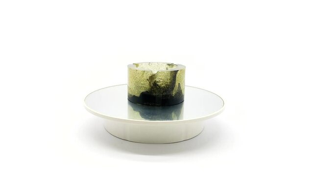 Fiberglass ashtray on a rotating board. Isolated on white background.