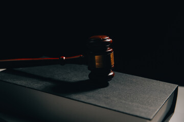 image of judge's hammer, scales lady of justice, law book, laptop computer and contract documents with pen concept of law and justice. © ARMMY PICCA