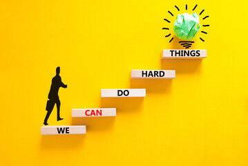 We can do hard things symbol. Concept words We can do hard things on wooden blocks. Beautiful yellow table yellow background. Businessman icon. Business, we can do hard things concept. Copy space.