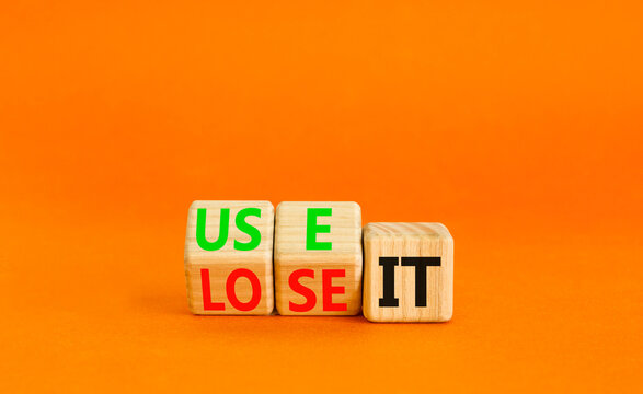 You use or lose it symbol. Concept word Use It or lose it on wooden cubes. Beautiful orange table orange background. Business and you use or lose it concept. Copy space.