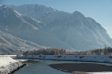 Obraz premium Snow covered landscape panorama at the rhine river in Vaduz in Liechtenstein