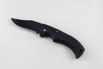 Folding tourist knife with a gray handle and black blade on a white background. Tourist knife for tourism, hunting and fishing. Insulated.