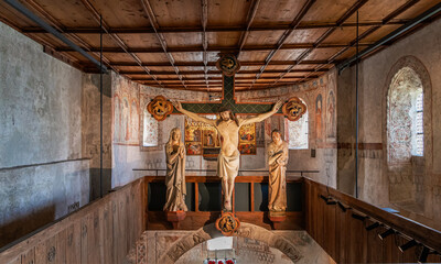 Tyrol Castle, Merano on South Tyrol, Trentino Alto Adige, Italy, June 14, 2023: interior of the Castle: lower chapel with Crucifixion group, (around 1330) - obrazy, fototapety, plakaty