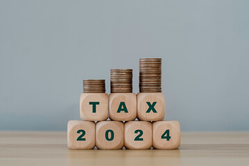 Word tax with number 2024. Tax icon in the wooden cube for income tax return and submit tax for...