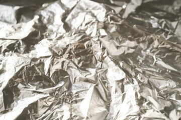 Abstract background made of crumpled silver foil.