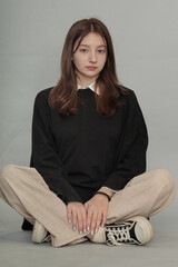 Reflective young teen in a simple black hoodie, the unadorned fabric offering space for branding...