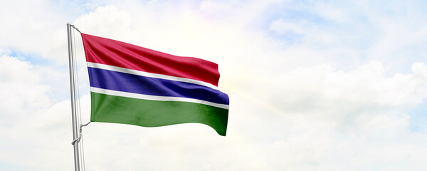 Gambia flag waving on sky background. 3D Rendering