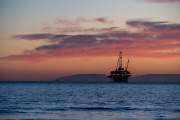 oil rig at sunset beach