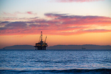 oil rig at sunset beach