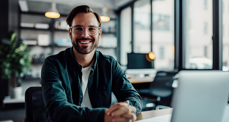 smiling businessman working with his laptop in the office