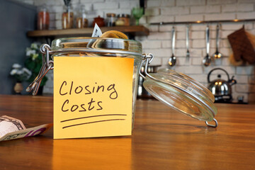 Jar with mark closing costs in home.