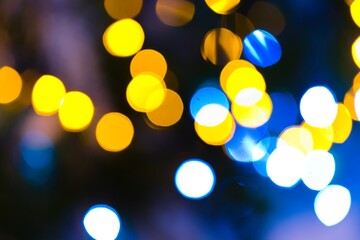 A mesmerizing image captures the enchanting glow of blurred lights on a Christmas tree, creating a...