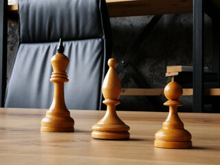 Chess pieces with a king as a symbol of succession planning and hierarchy.