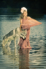Young lady as a water fairy in middle of summer time lake
