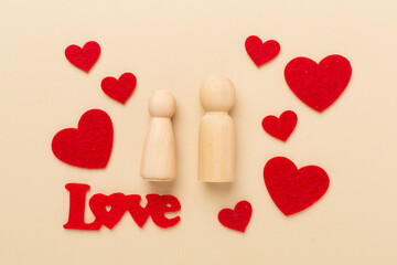 Wooden couple in love on color background, top view. Creative valentine's day composition