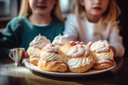 Children hold a plate of whipped cream-topped Swedish semla buns
