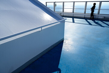 woman looking at the sea on top of a cruise ship sailing in the Mediterranean
​
