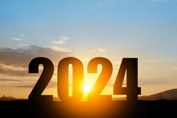 Silhouette 2024 with sunset sky at mountain and number like 2024 abstract background. Concept of...