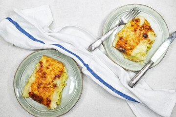 Traditional chicken shepherd pie offered as closeup in a rustic ceramic modern design plate