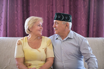 Their laughter fills the room, the woman's eyes twinkling at her partner's adorned headwear, a sign...