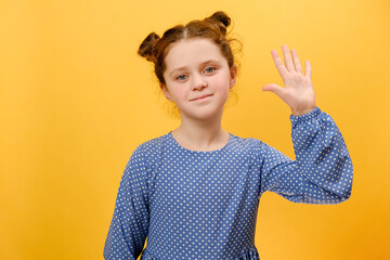 Portrait of preteen girl kid waving hand gesturing hello, smiling looking at camera, isolated on...